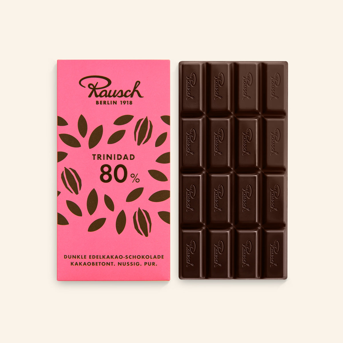 Dunkle, handwerkliche Schokolade 80% Kakao in rechteckiger Tafel mit Prägung neben pinker Verpackung mit Blattmotiv. - Rausch