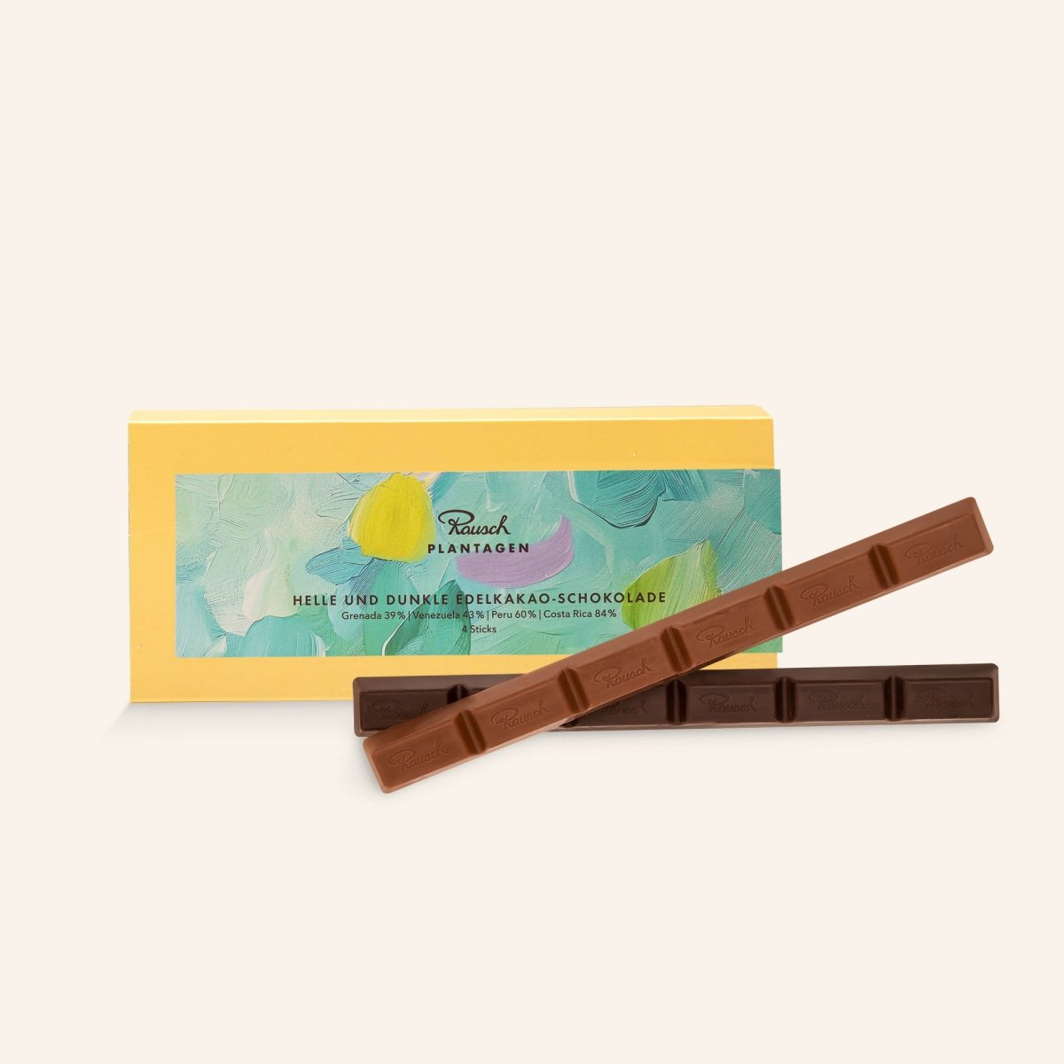 Gelbe Verpackung befüllt mit Rausch Edelkakao-Schokolade-Sticks hell & dunkel